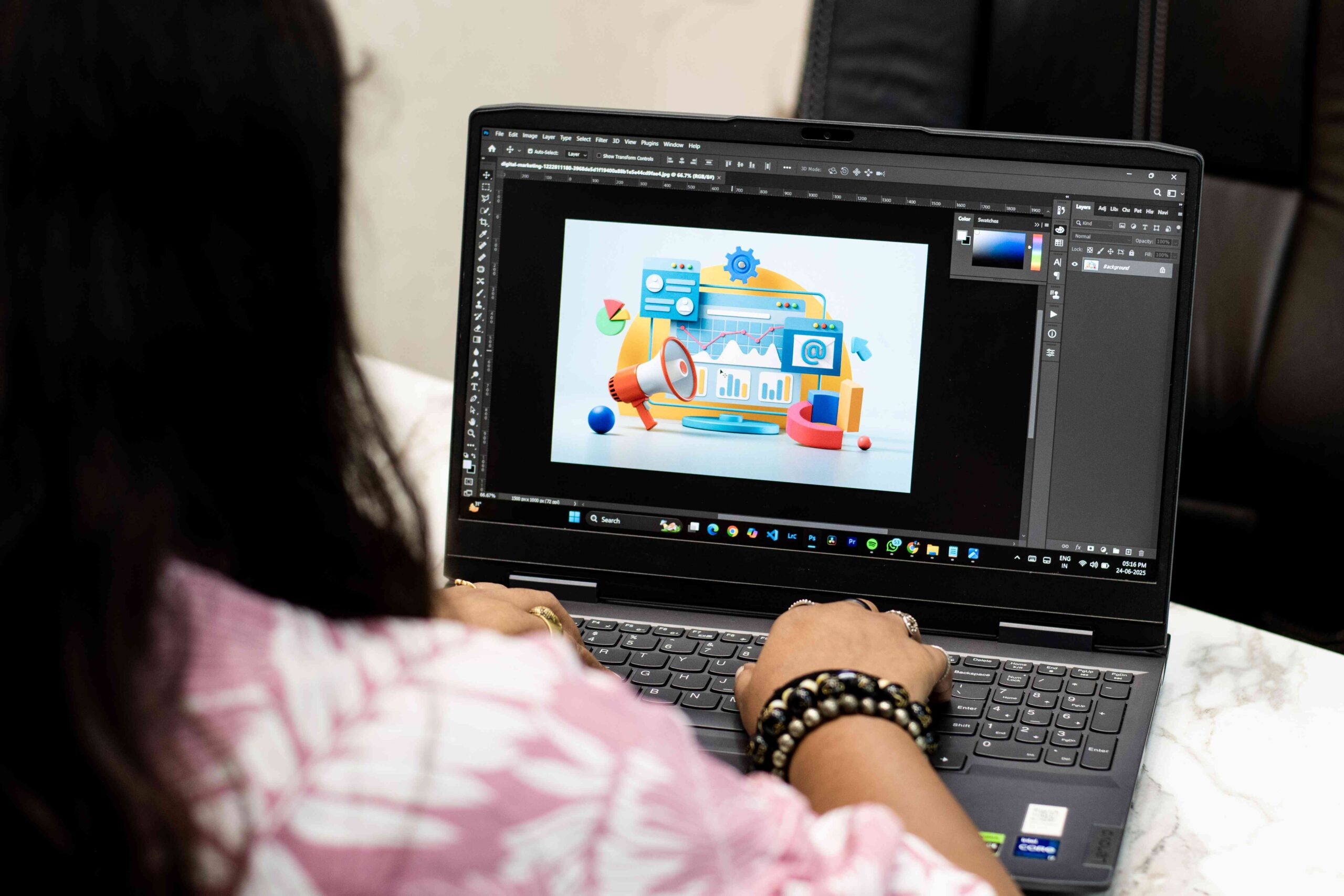 Student designing a digital graphic using Photoshop