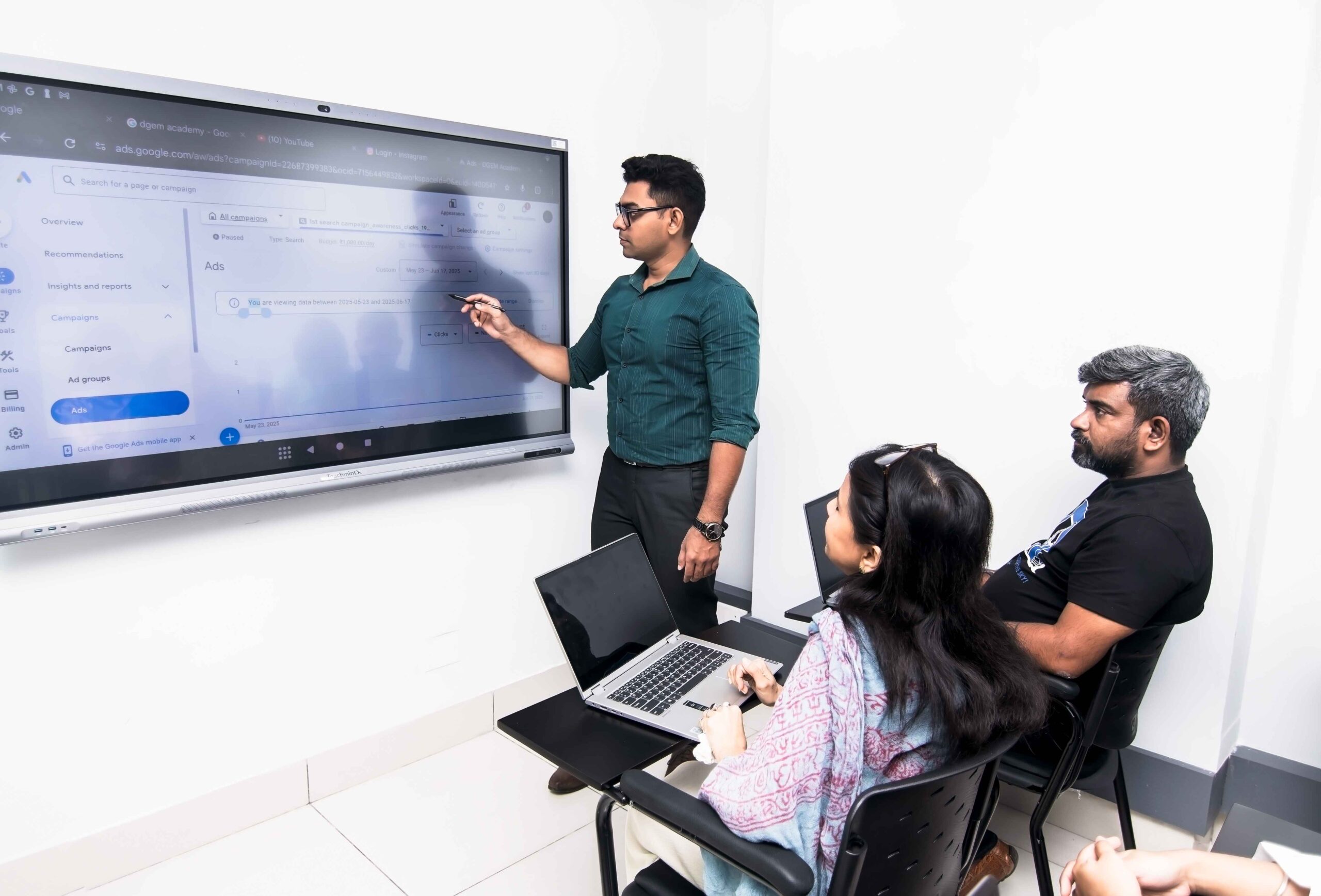 Instructor teaching advanced digital marketing on smart screen to engaged learners