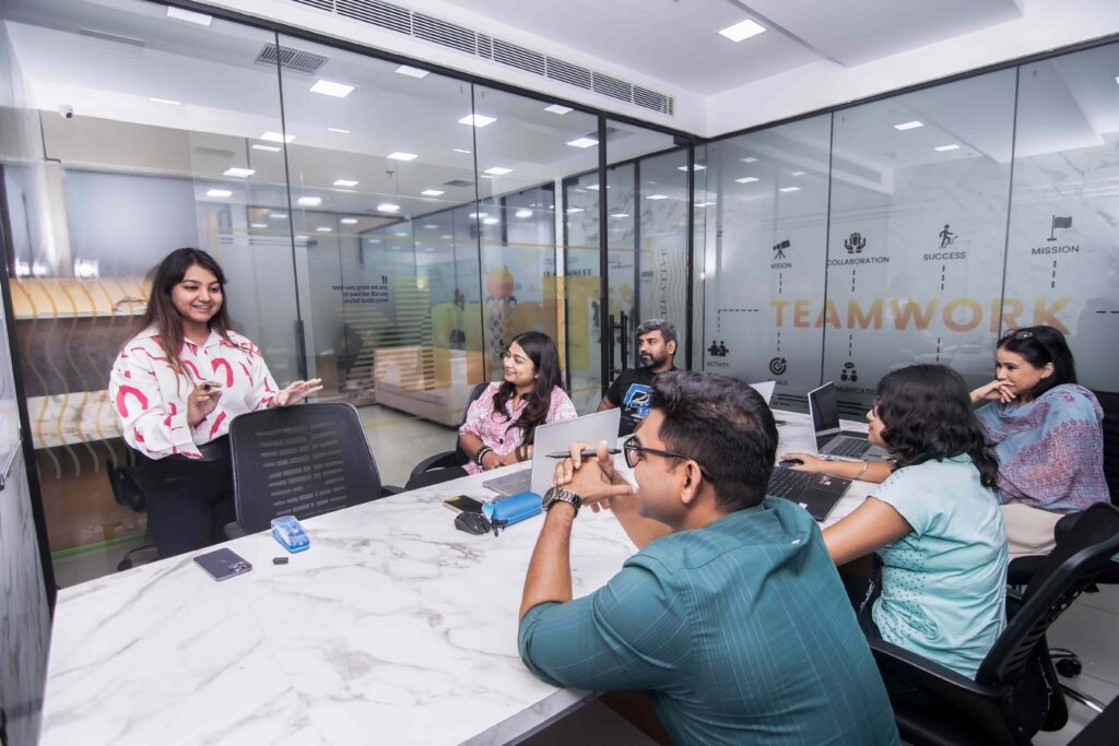 Team in a digital marketing training session, collaborating in a modern office